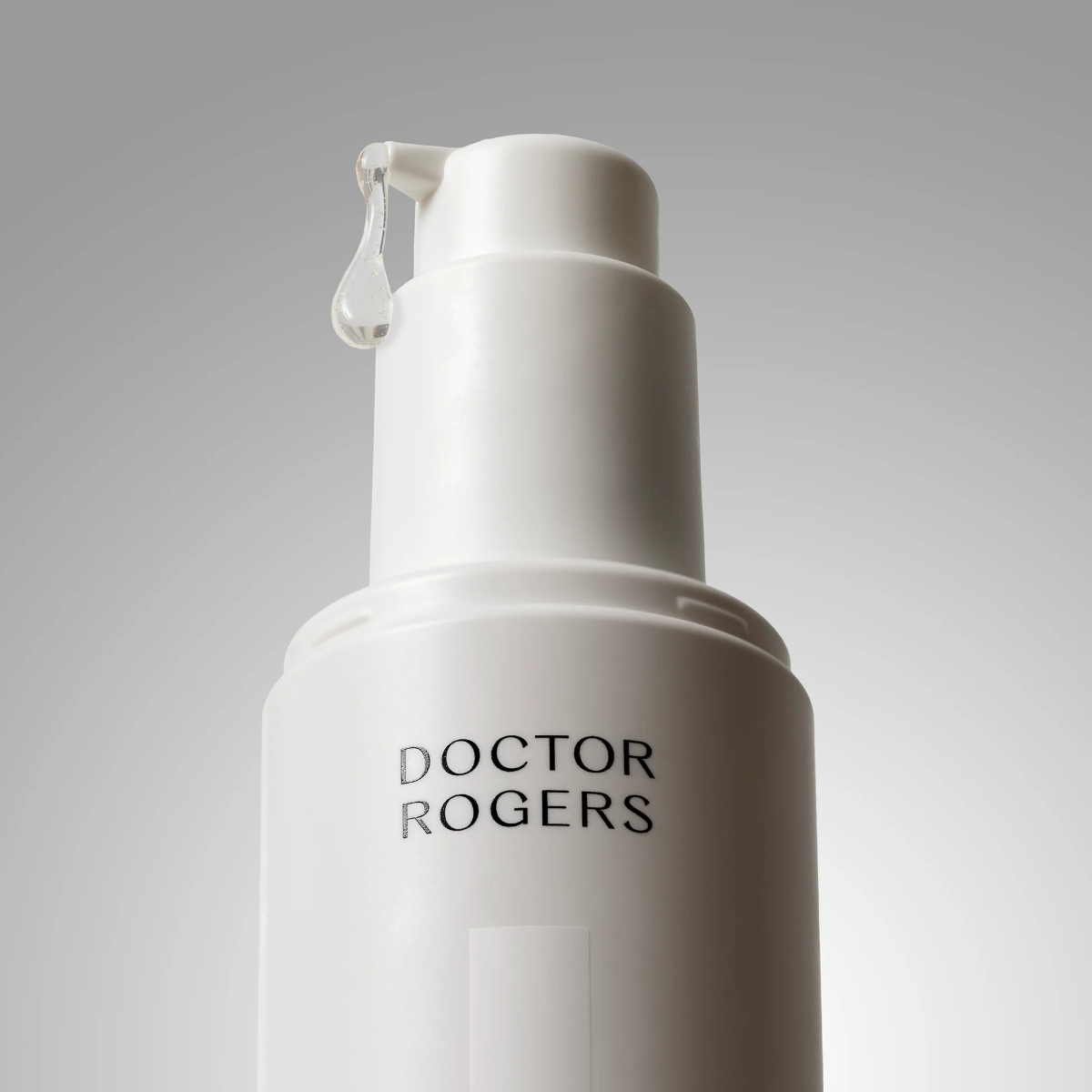 White skincare bottle with 'Doctor Rogers' branding on a gray background