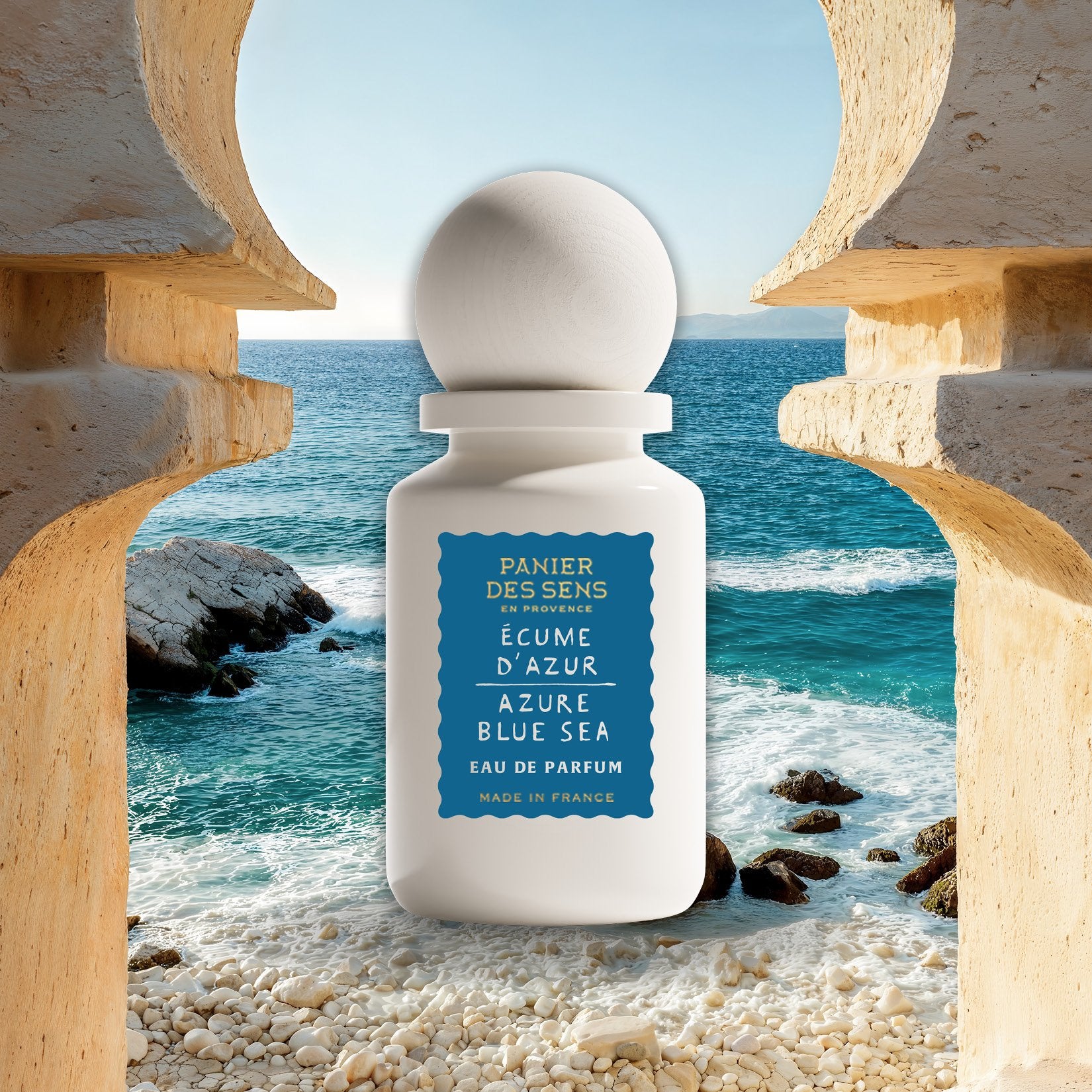 Azure Blue Sea white perfume bottle with blue label on a beach setting