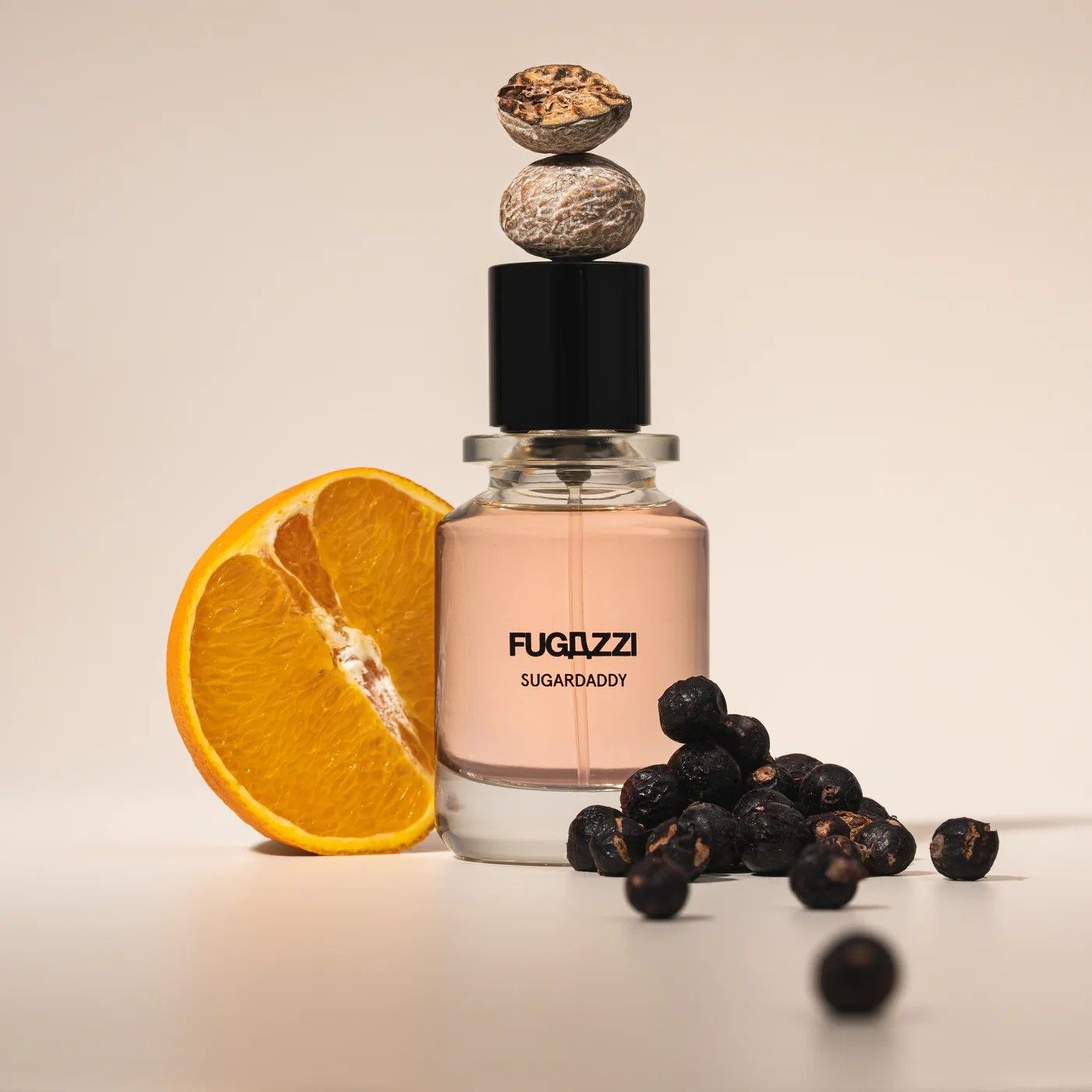 Fugazzi Sugardaddy bottle on white background. with nutmeg, juniper berries and half an orange surrounding it.