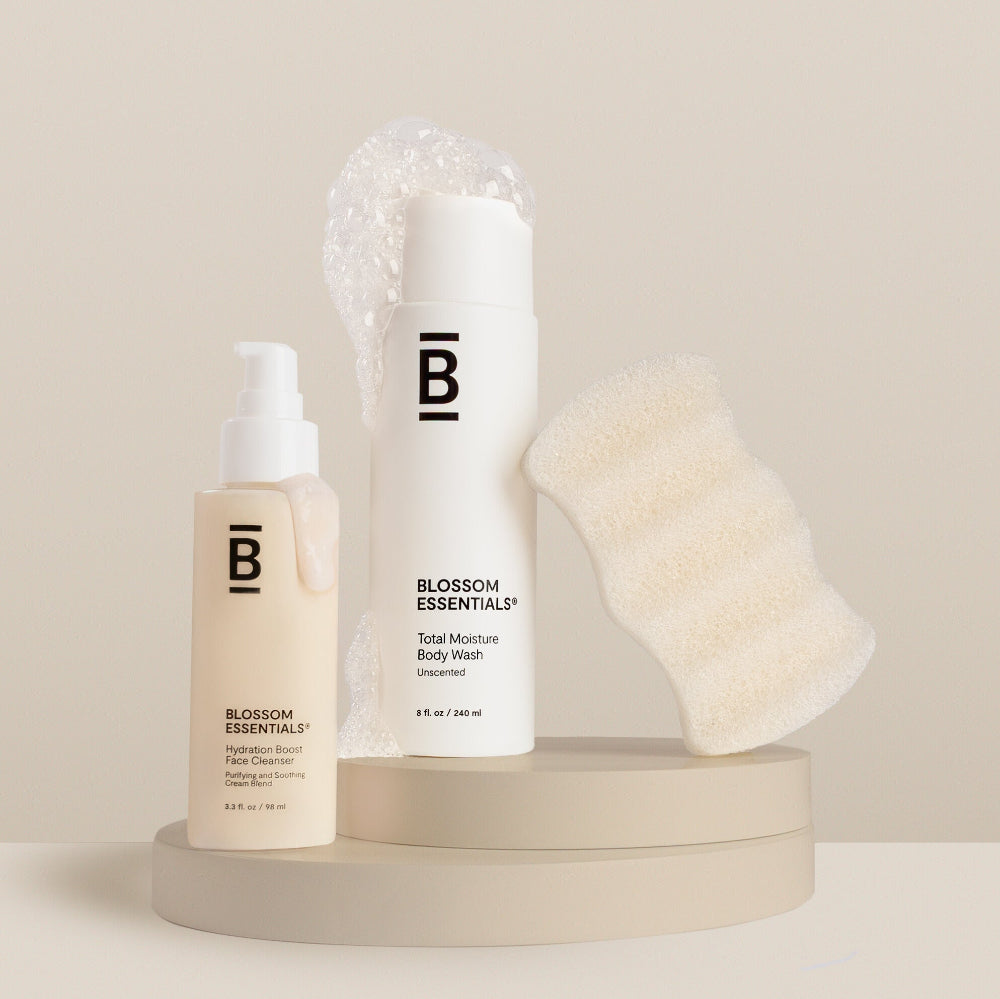 Blossom Essentials skincare products including a bottle, cleanser, and scrub on a neutral background