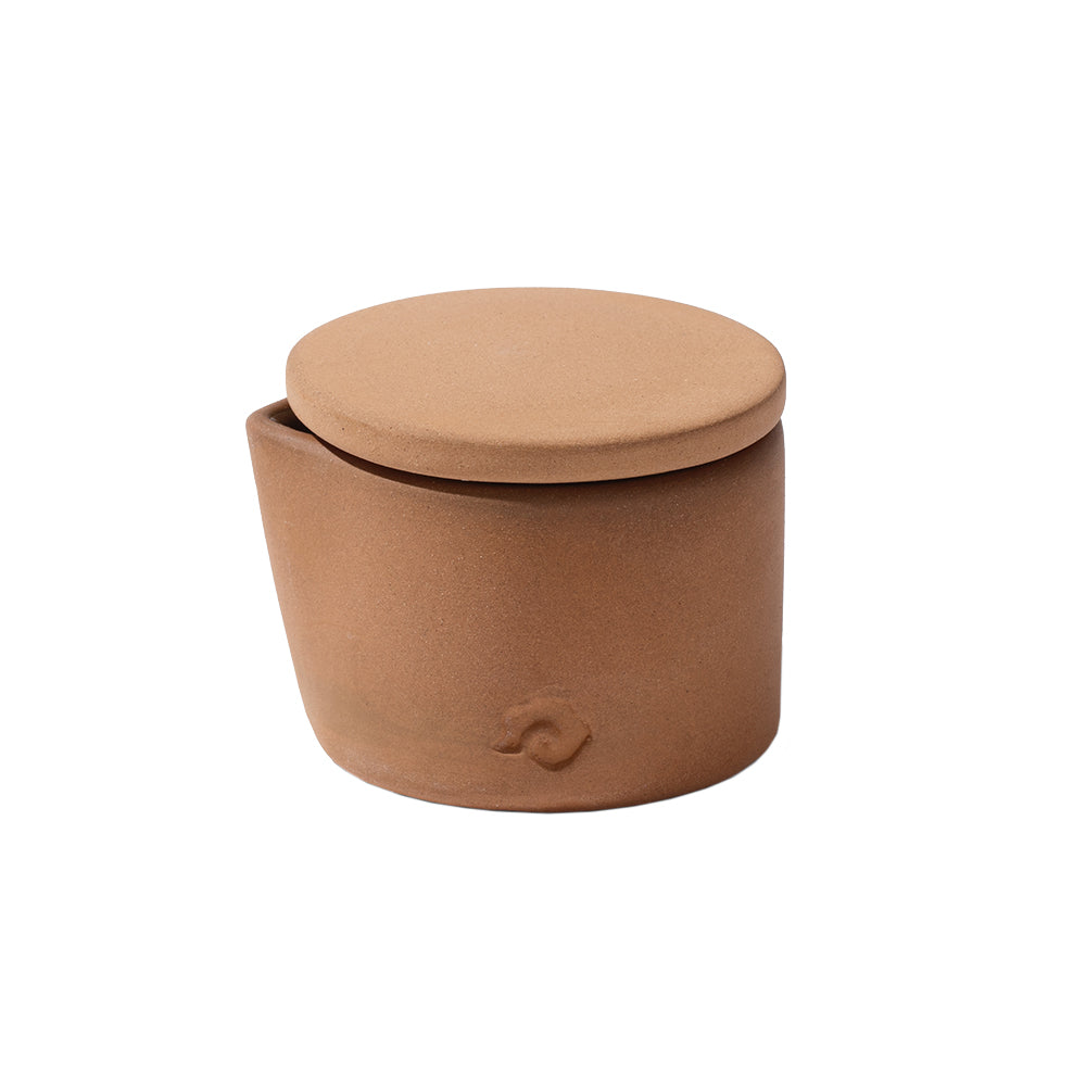 Brown cylindrical container with a lid on a white background