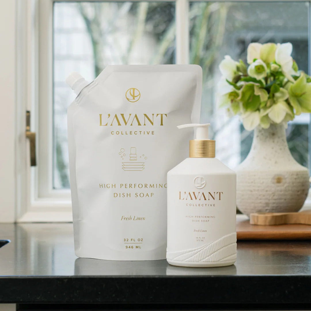 L'Avant dish soap bottle and container on a kitchen counter with a window in the background.