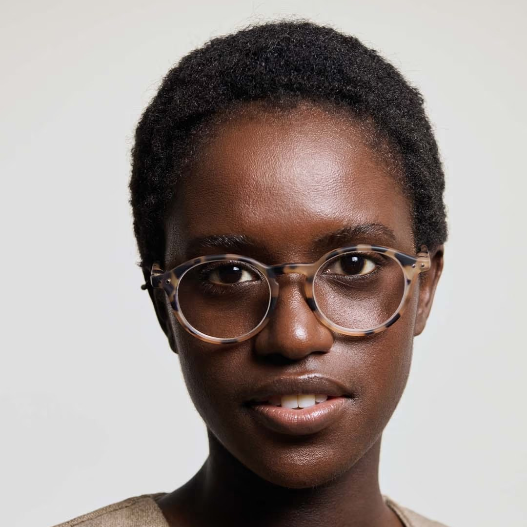 Woman wearing glasses with a plain background