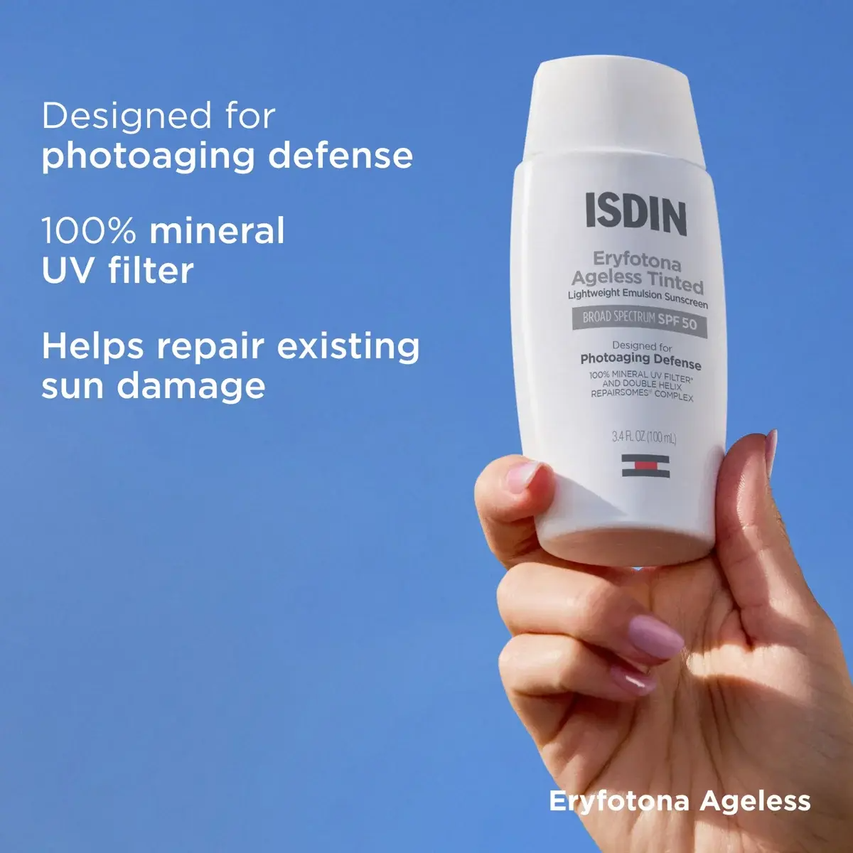 Hand holding ISDIN sunscreen against a blue sky background with white text detailing the product