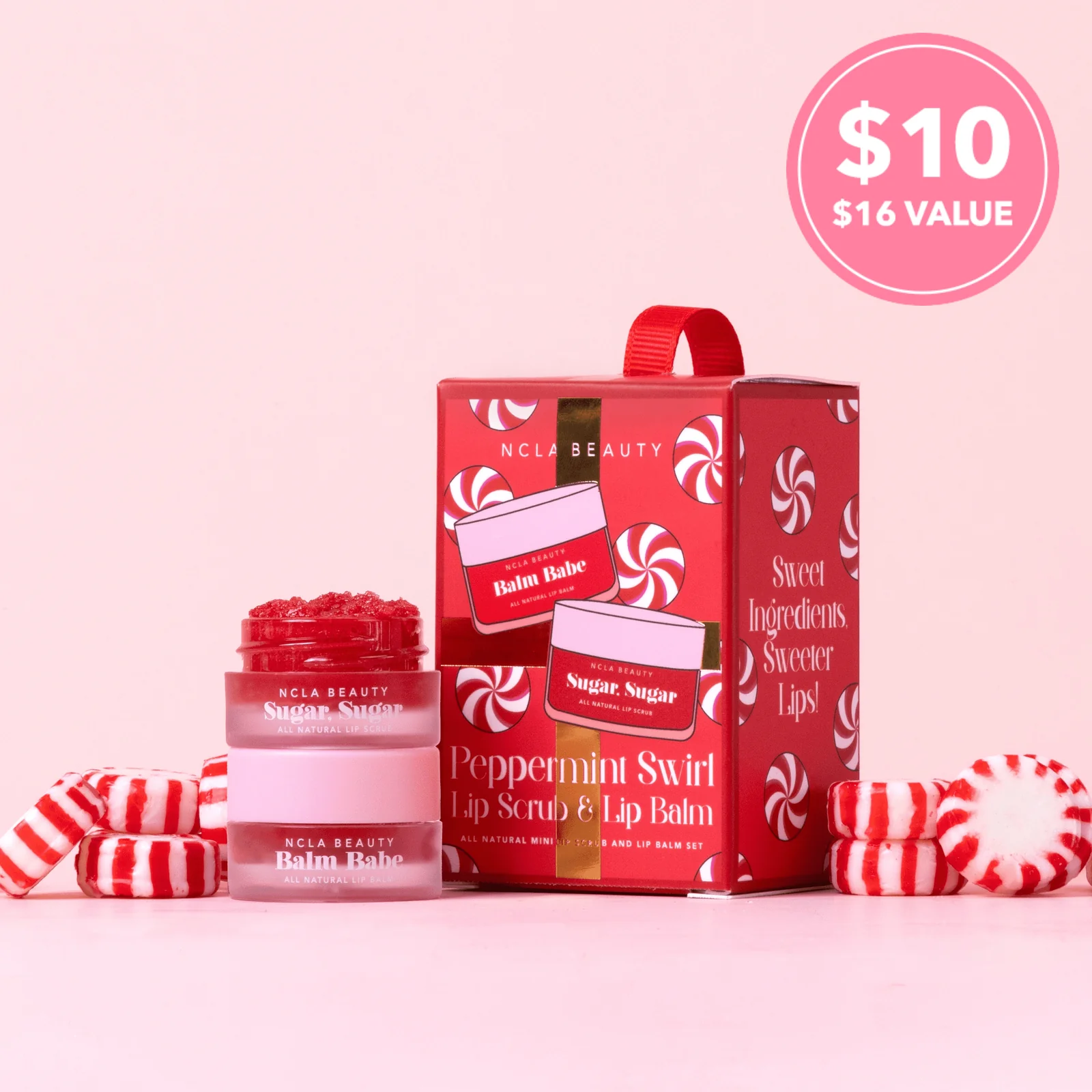 NCLA Beauty peppermint swirl lip scrub and lip balm set with packaging on a pink background