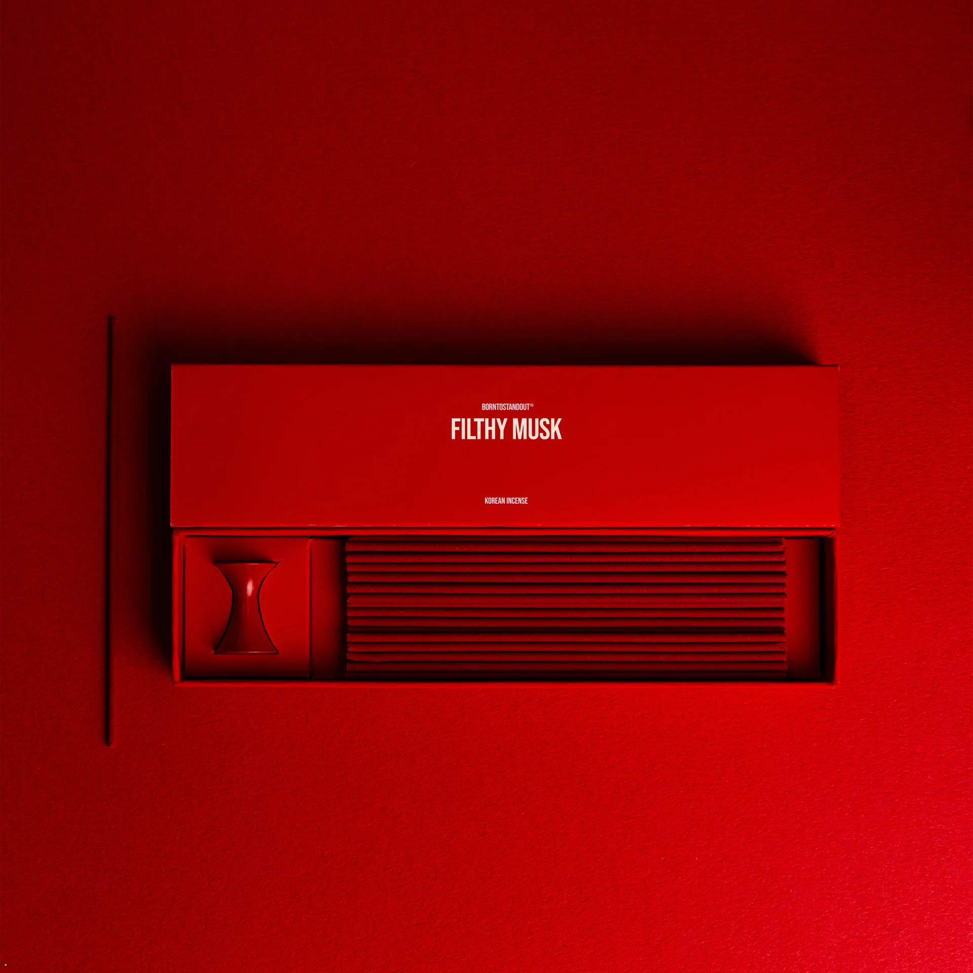 Filthy Musk Incense box on a red background.