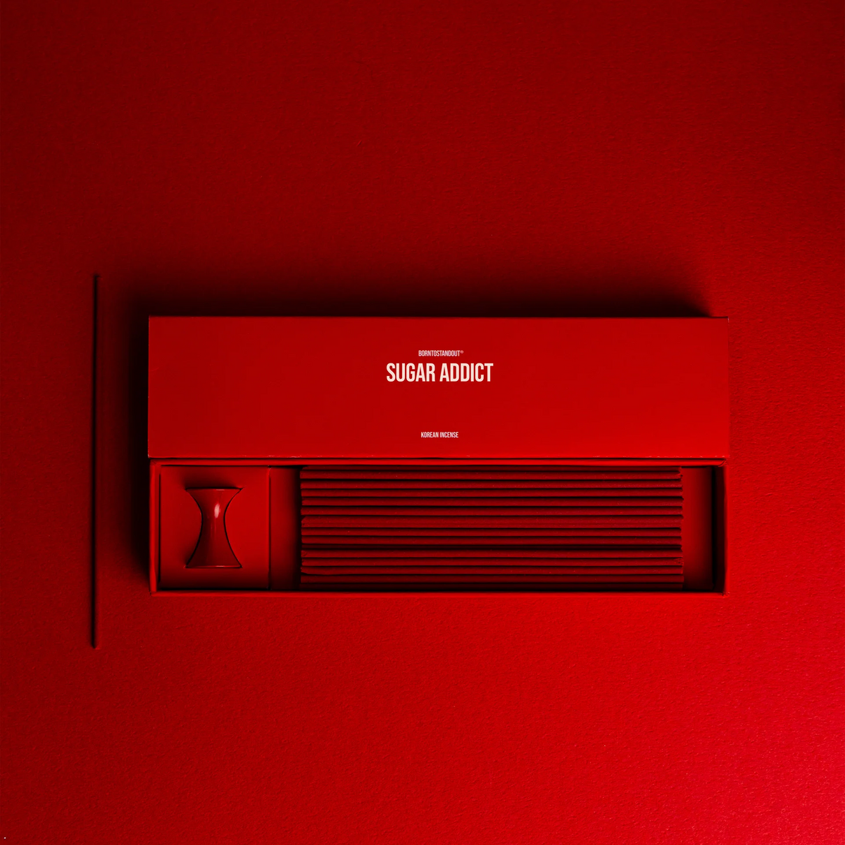Sugar Addict Incense box on a red background.