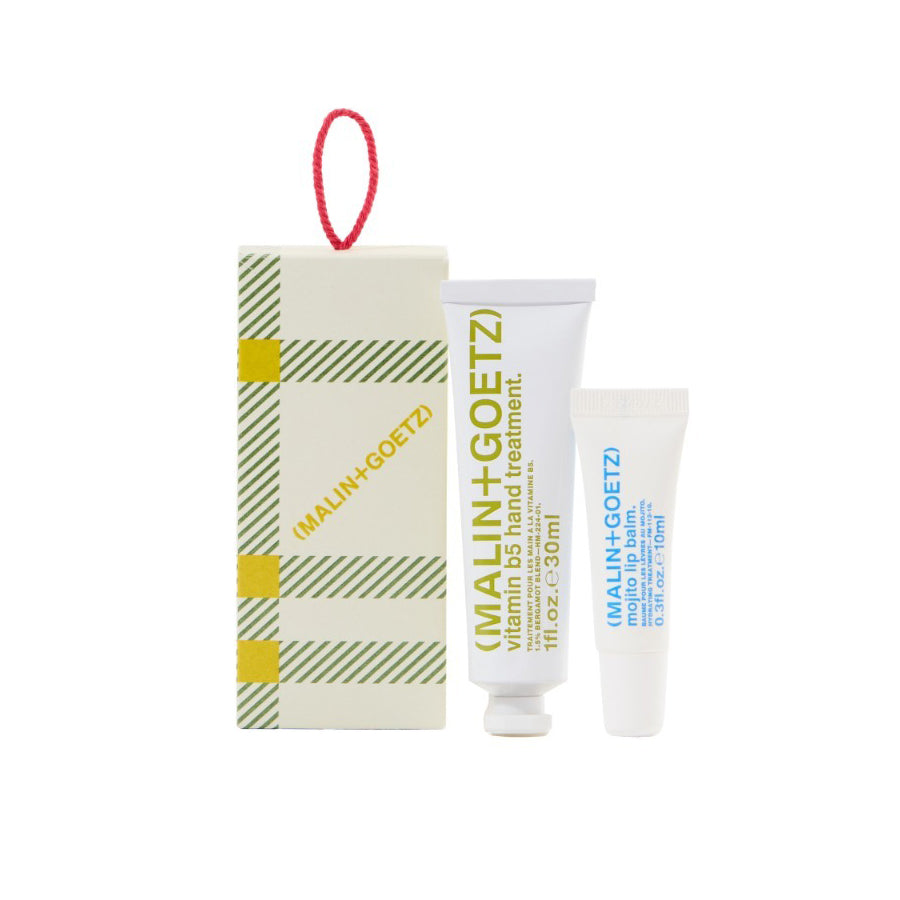 Malin+Goetz lip balm and hand treatment with packaging on a white background