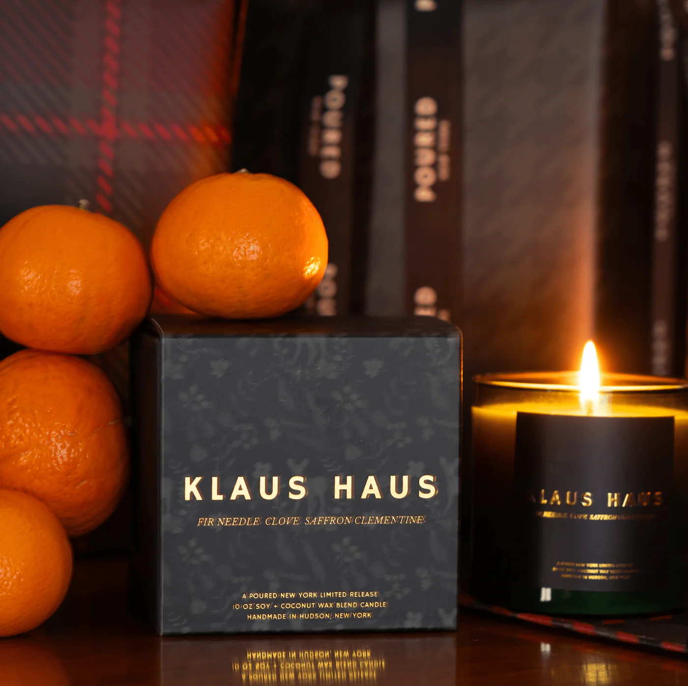 Klaus Haus candle with oranges and a blurred background