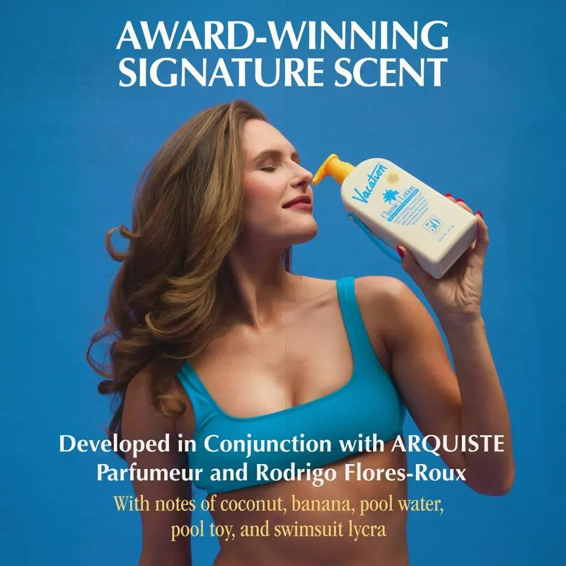 Woman holding a bottle of sunscreen with text about an award-winning signature scent.