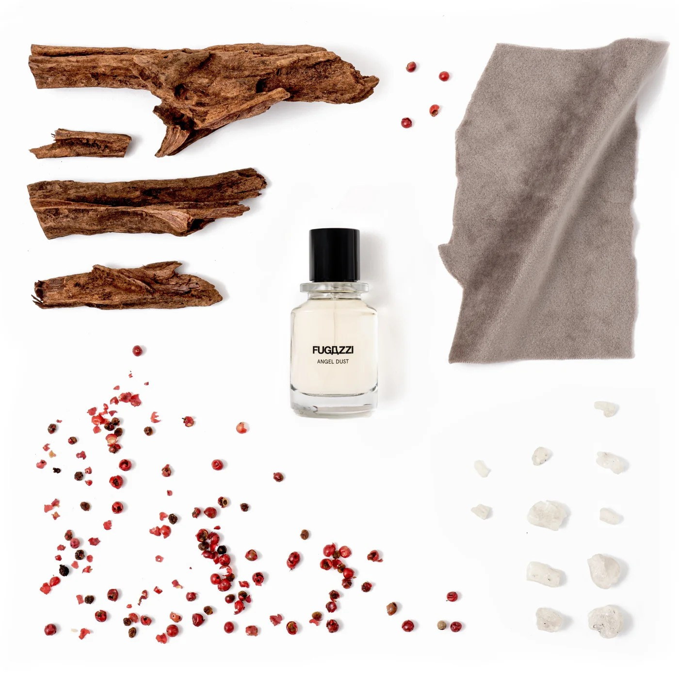 Fugazzi Angel Dust Bottle on white background with bark and white crystals and red peppercorns around it.