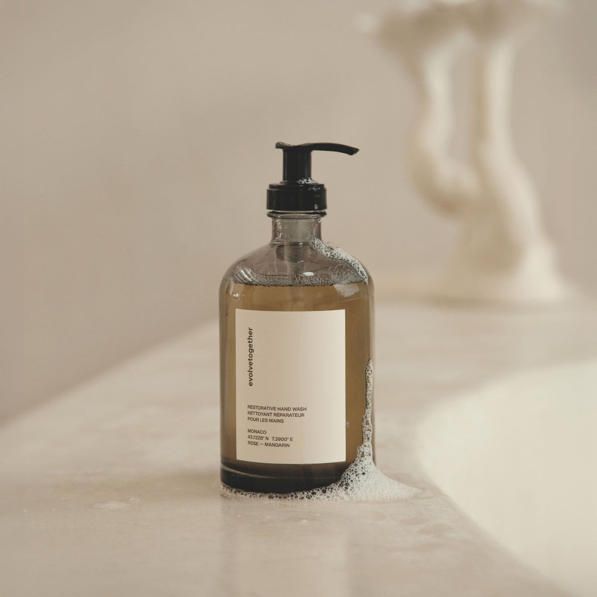 Hand soap bottle with pump on a neutral background