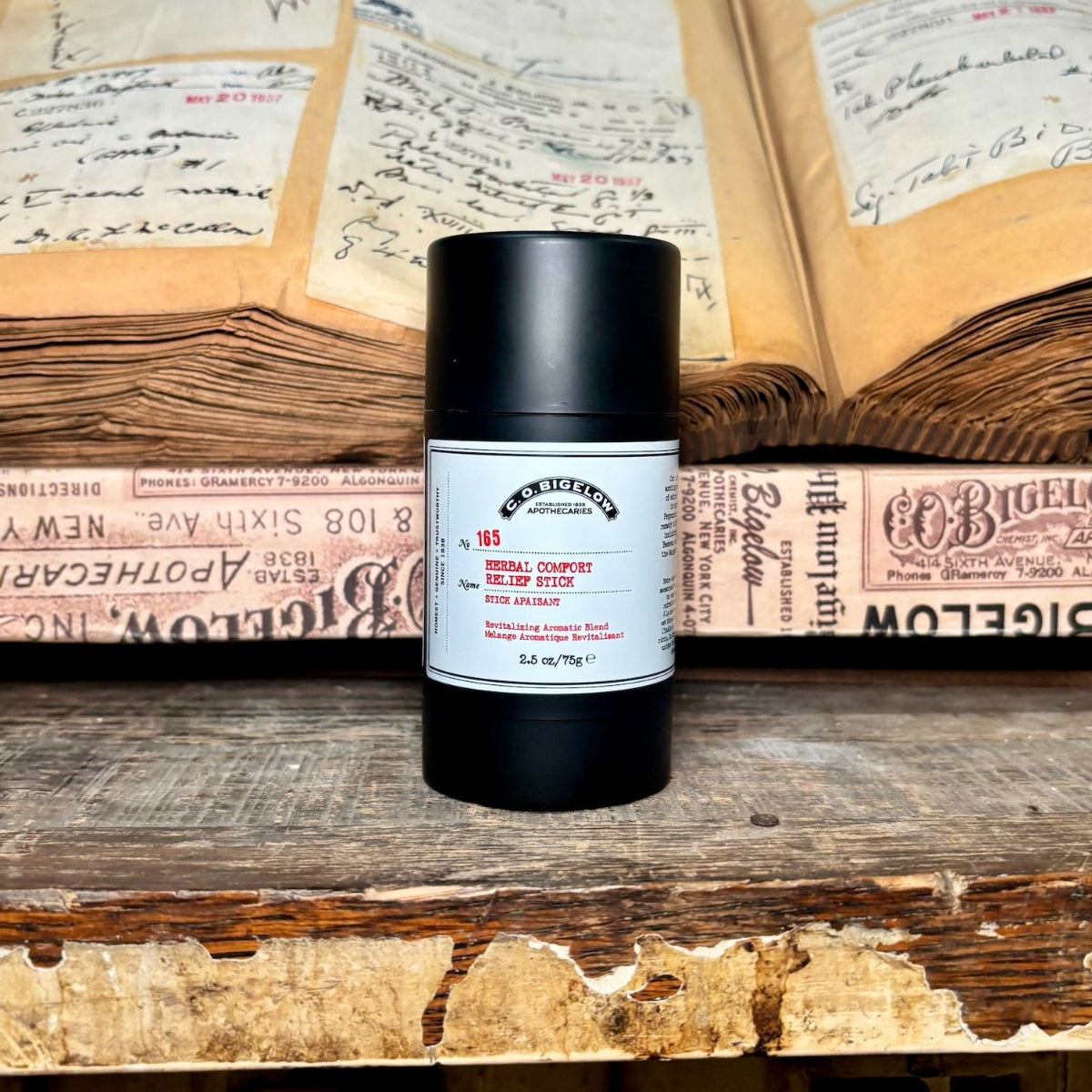 Deodorant stick on an open book with visible text