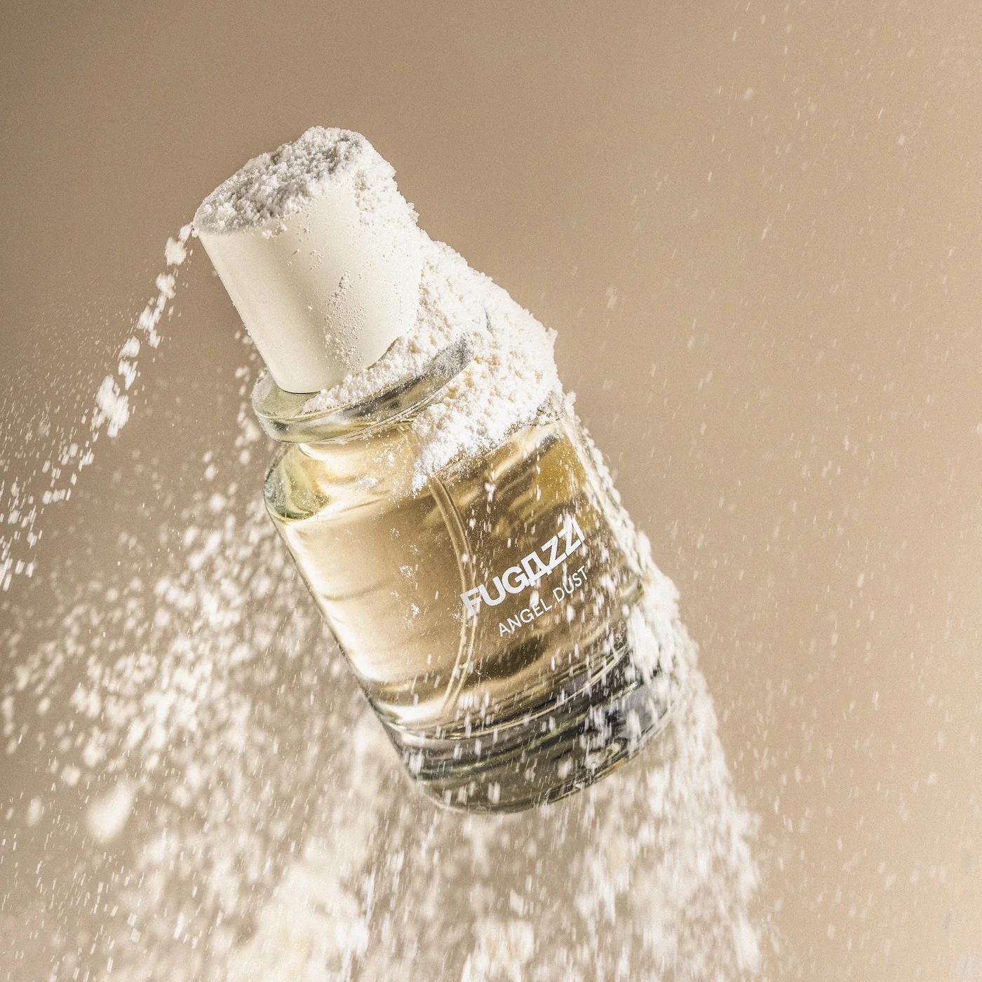 fugazzi angel dust perfume bottle with white powder being blown off it.