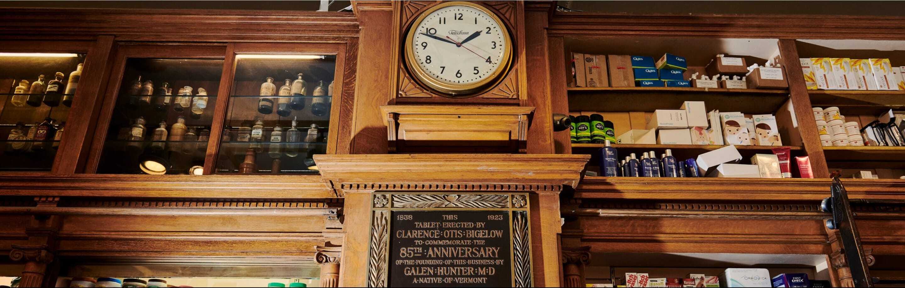 A traditional clock affixed to a wooden wall, emphasizing the harmonious blend of timekeeping and natural materials.