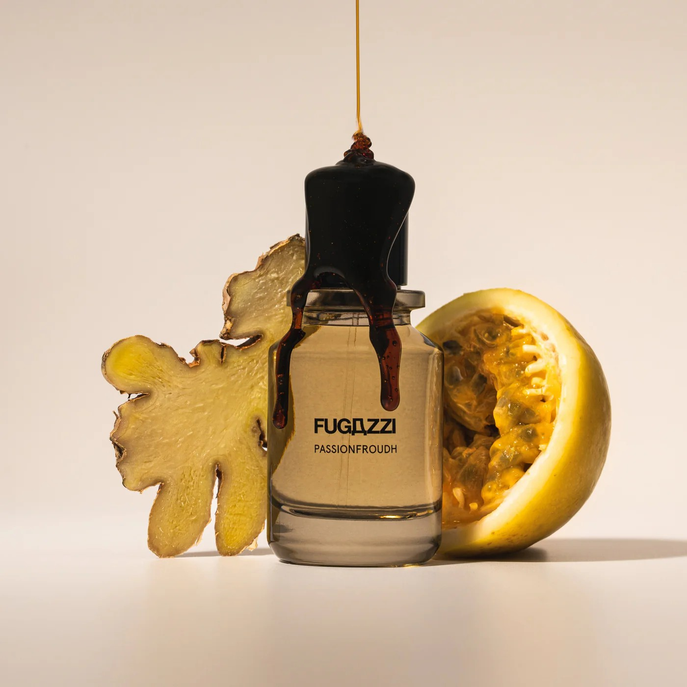 Fugazzi Passionfroudh bottle with a slice of ginger root and passionfruit slice on each side of the bottle with brown syrup being poured over it.