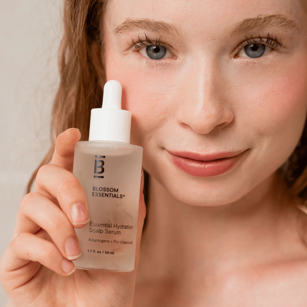 Woman holding Blossom Essentials Hydration Scalp Serum