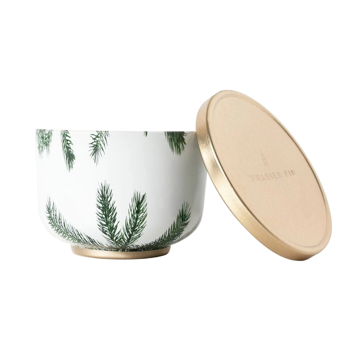 Candle with green fir design and gold lid on a white background