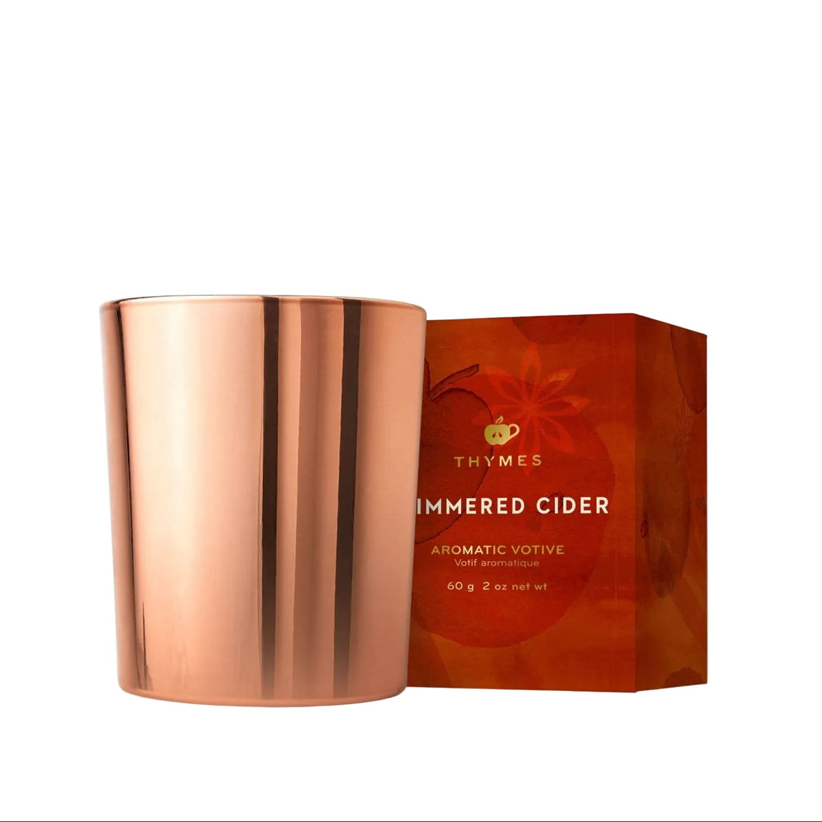 Copper candle holder with Thymes 'Ambered Cider' packaging on a white background