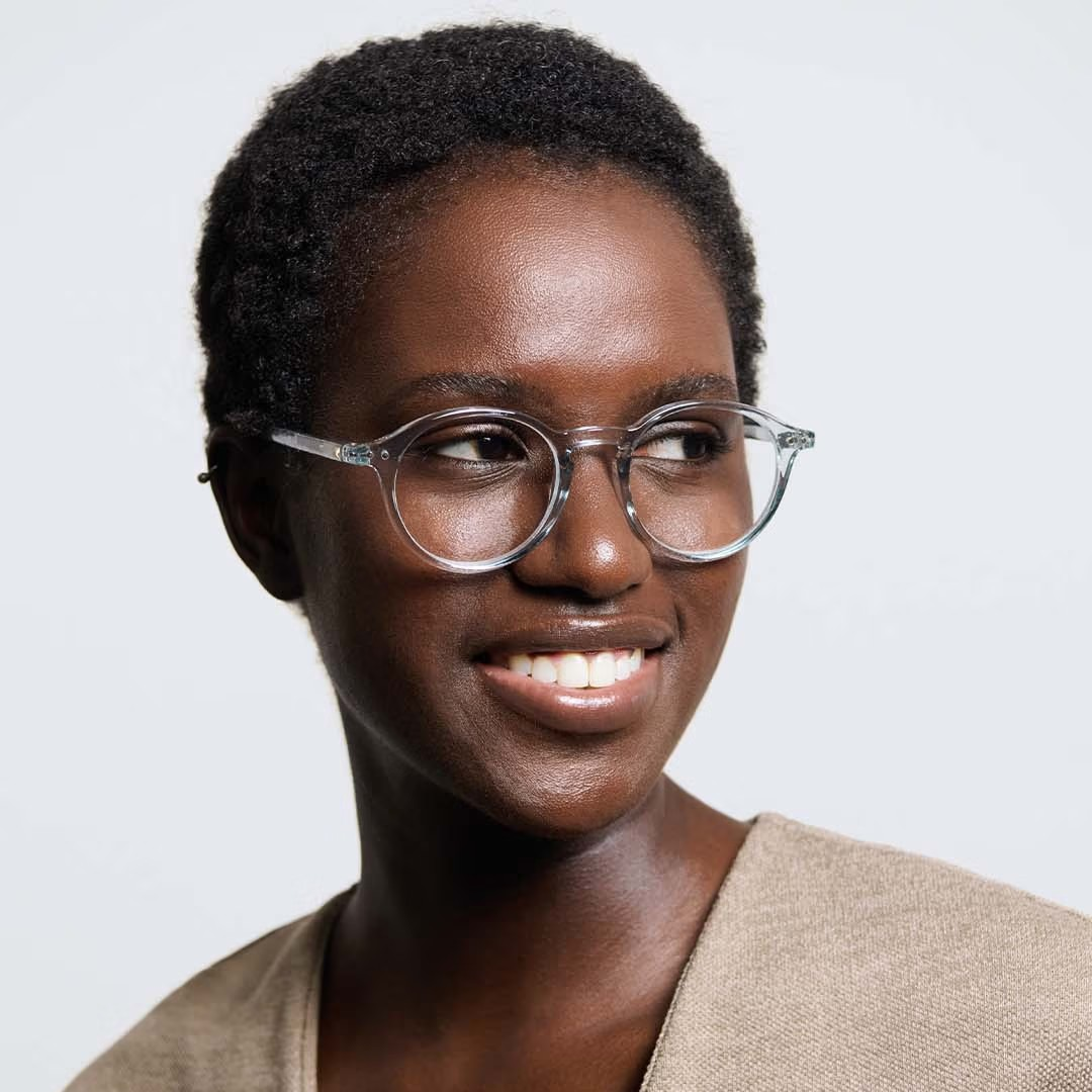 Woman wearing glasses with a plain background